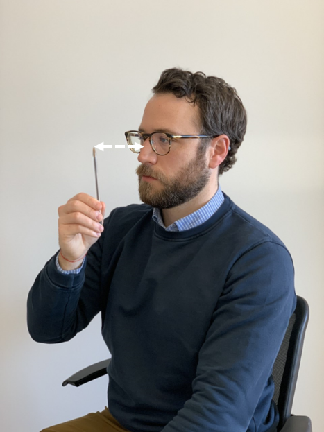 person sitting in seat moving arms horizonatally and vertically with directional arrows to show movement