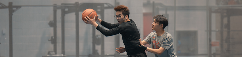 Two men playing Basketball