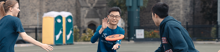 Man catching a frisbee throw by teammates