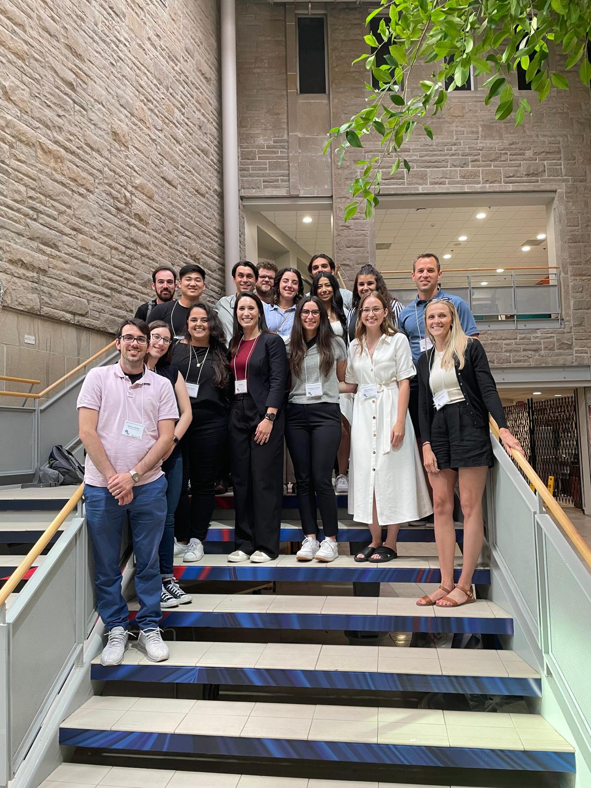 Lab members and KPE faculty members pose for group photo on stairs