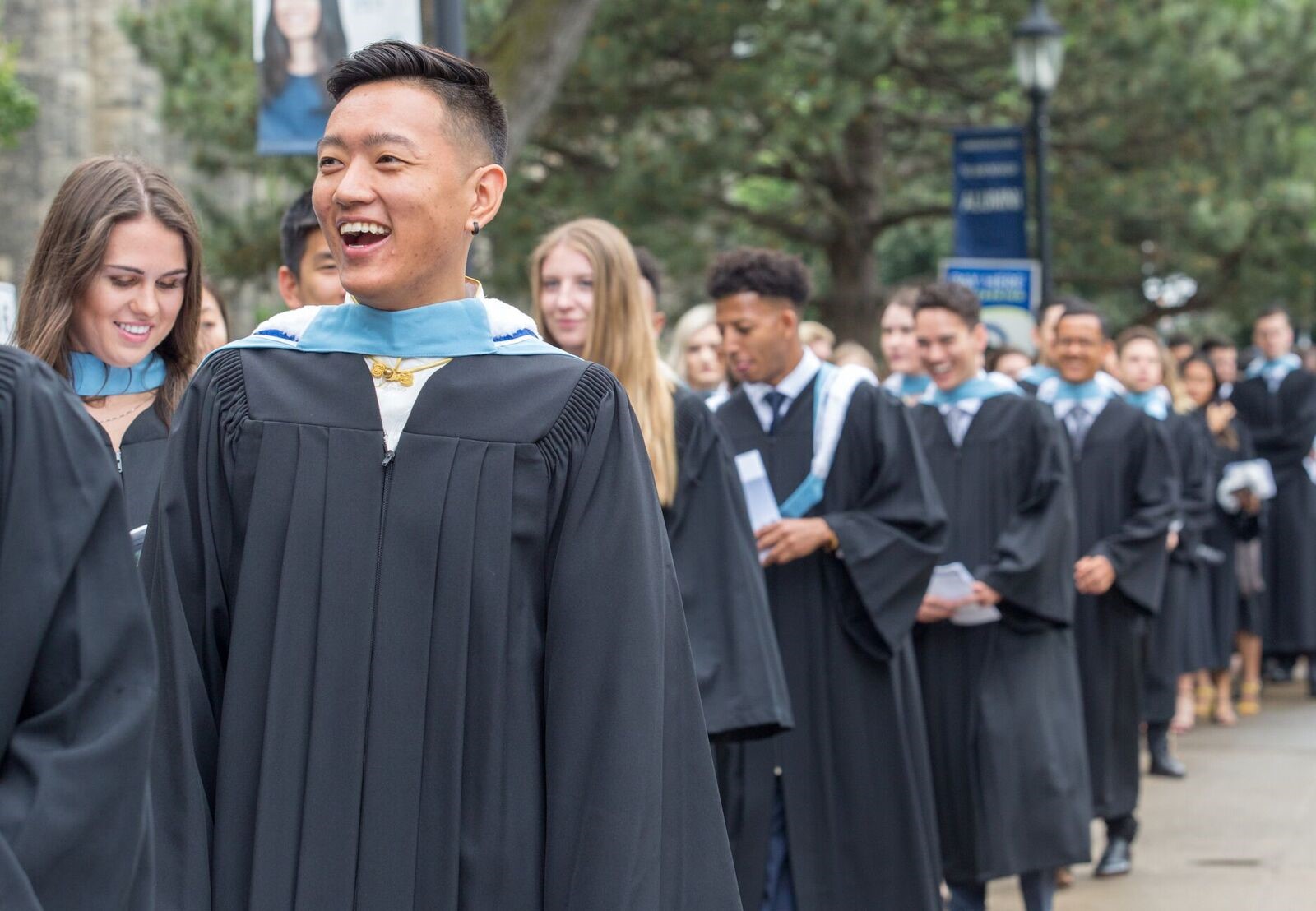 Procession of KPE students walking to Convocation Hall for their graduation ceremony