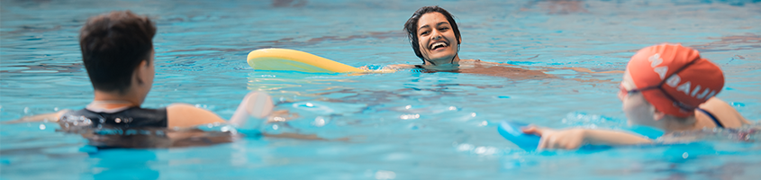 Three people swimming in the pool