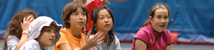 Children sitting together talking while watching sports